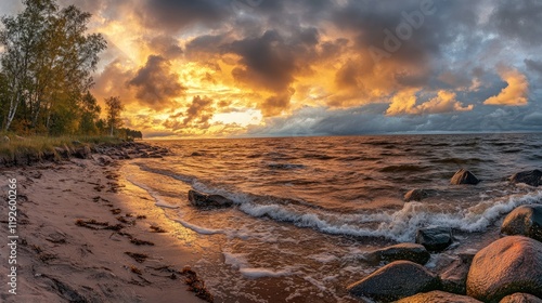 Fototapeta Naklejka Na Ścianę i Meble -  Baltic Sea sunset after storm showcasing dramatic skies glowing clouds and splashing waves in a picturesque coastal landscape