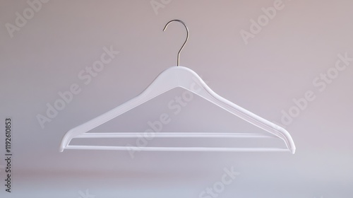 Minimalist white plastic hanger suspended against a soft background for clothing display and retail presentation concepts. photo