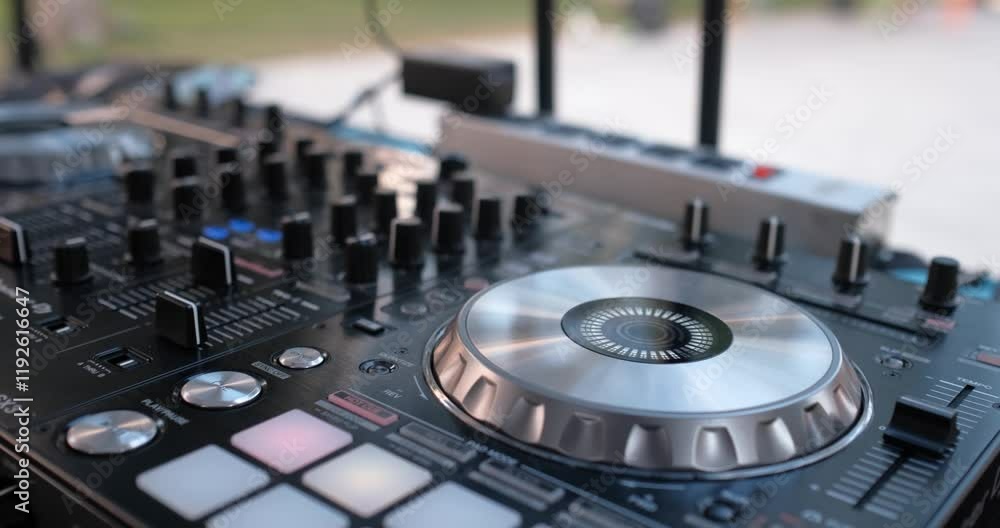 Detail of control table being operated by DJ at social event Detail of control table being operated by DJ at social event