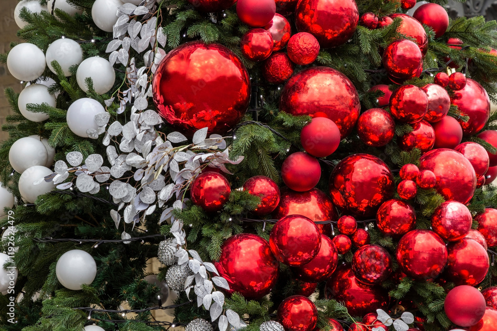 Red and white balls among fir branches. New Year's composition