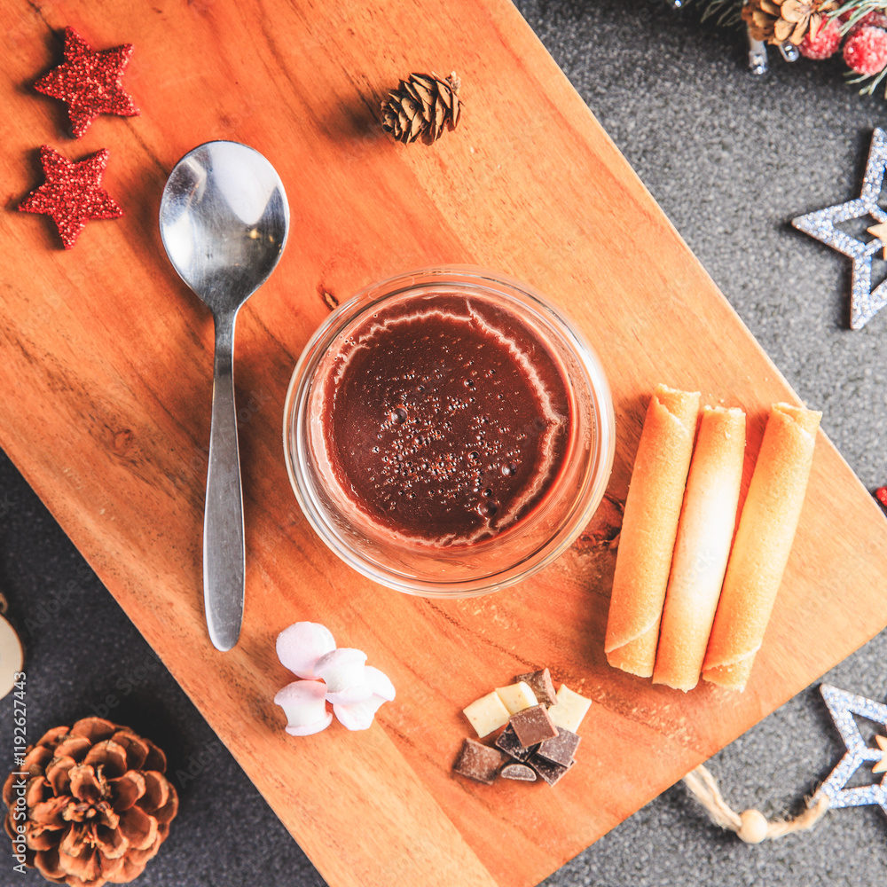 Traditional hot chocolate with marshmallows and chocolate chips in a Christmas decoration