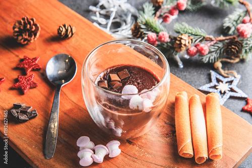 Traditional hot chocolate with marshmallows and chocolate chips in a Christmas decoration