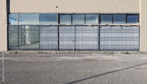Wallpaper Mural Closed store under refurbishment,  with shutter security gates and padlock. Street in front. Background for copy space Torontodigital.ca