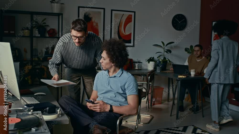 Group of multi-ethnic people having casual conversations during work day, asking colleagues for help in modern open space office Group of multi-ethnic people having casual conversations during work day, asking colleagues for help in modern open space office