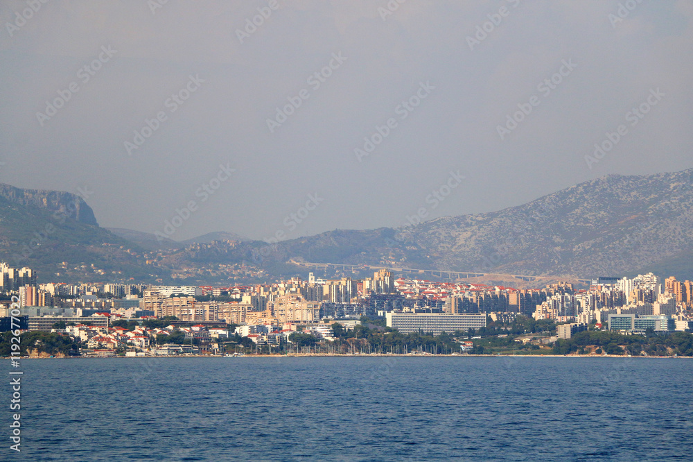 Contemporary buildings, gardens and beaches at the waterfront in Split, Croatia. View of Split from the boat. Contemporary buildings, gardens and beaches at the waterfront in Split, Croatia. View of Split from the boat.