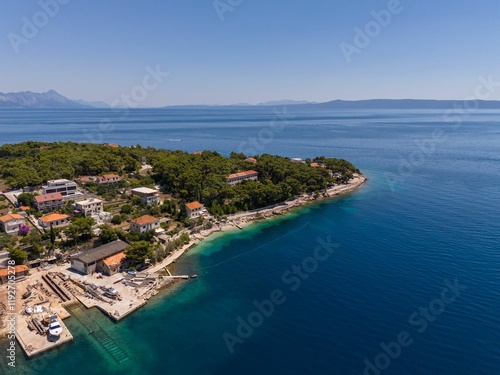 Wallpaper Mural Aerial view of a coastal village with lush greenery and clear blue waters. Bol, Croatia Torontodigital.ca