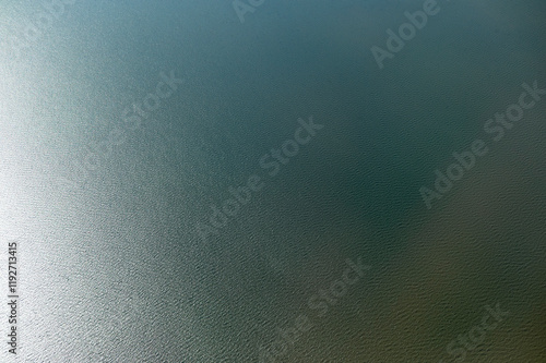 Aerial view shot from a plane of a calm, expansive body of water with a gradient of blue shades and gentle ripples on the surface, near New Orleans, USA photo