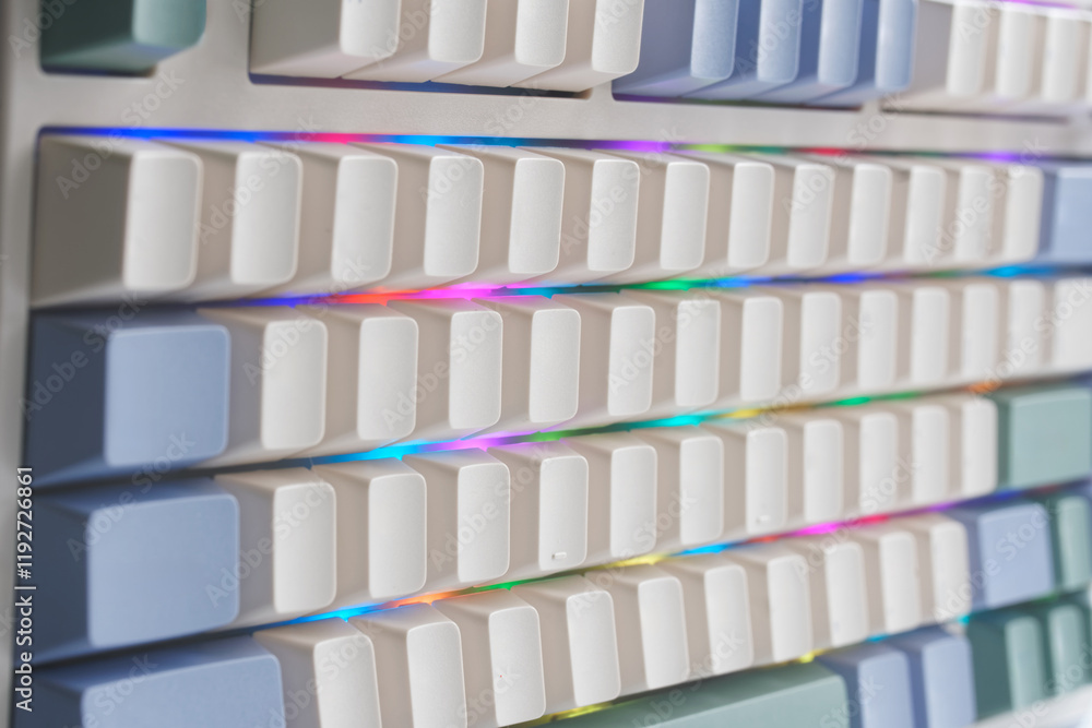 Light mechanical computer keyboard with multi-colored RGB backlight. Elegant design without letters, without symbols and without signs. For gamers and designers. Photo. Selective focus Light mechanical computer keyboard with multi-colored RGB backlight. Elegant design without letters, without symbols and without signs. For gamers and designers. Photo. Selective focus