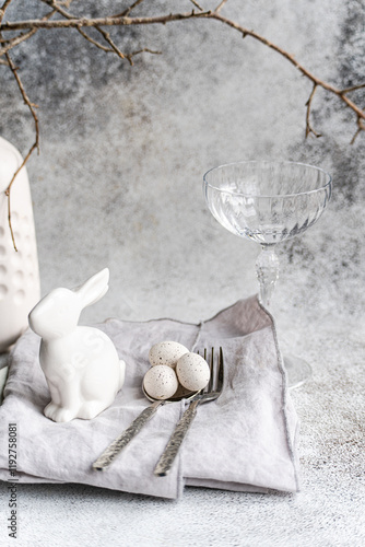 Easter setting with ceramic rabbit and speckled eggs photo