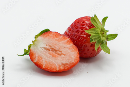 Isolated strawberries. Two cut strawberry fruits isolated on white background