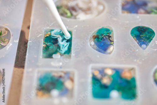 Crafting resin art: creating colorful ocean inspired jewelry with silicone molds and epoxy techniques. photo