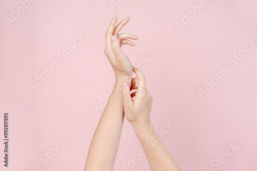 Manicured nails, beautiful woman hands forming an elegant shape on pink background photo