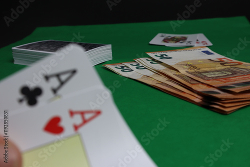 Poker cards pair of aces with money on a green table photo