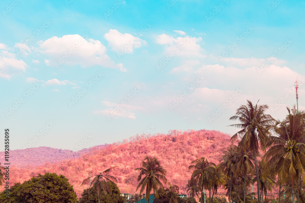 Infrared photography, a landscape with a light-pinkish-toned mountain range under a vibrant blue sky Infrared photography, a landscape with a light-pinkish-toned mountain range under a vibrant blue sky