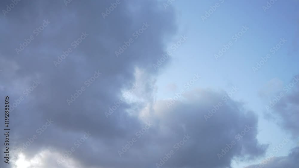 Low angle view of a dramatic cloudscape in blue, clear sky at sunset time in Kristiansund, Norway. Low angle view of a dramatic cloudscape in blue, clear sky at sunset time in Kristiansund, Norway.