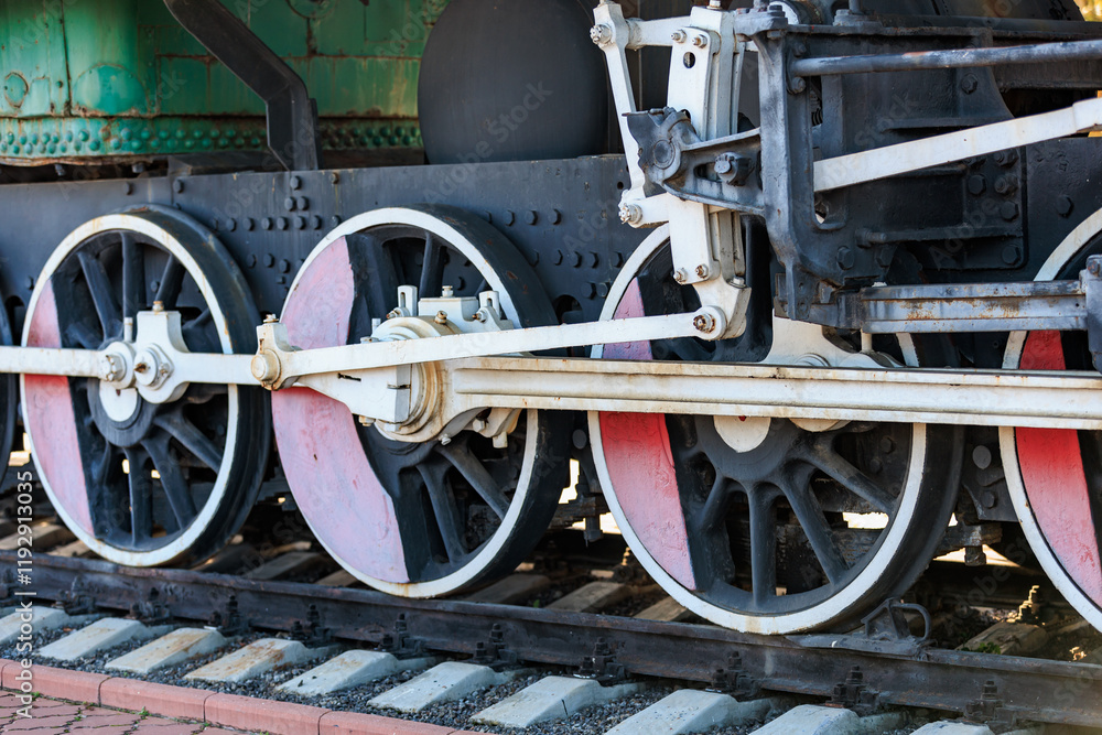 Fototapeta premium Vintage steam train wheels and gears in industrial setting