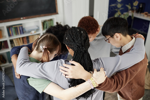 Photography High angle view at multiethnic group of teenagers huddling in circle during moti