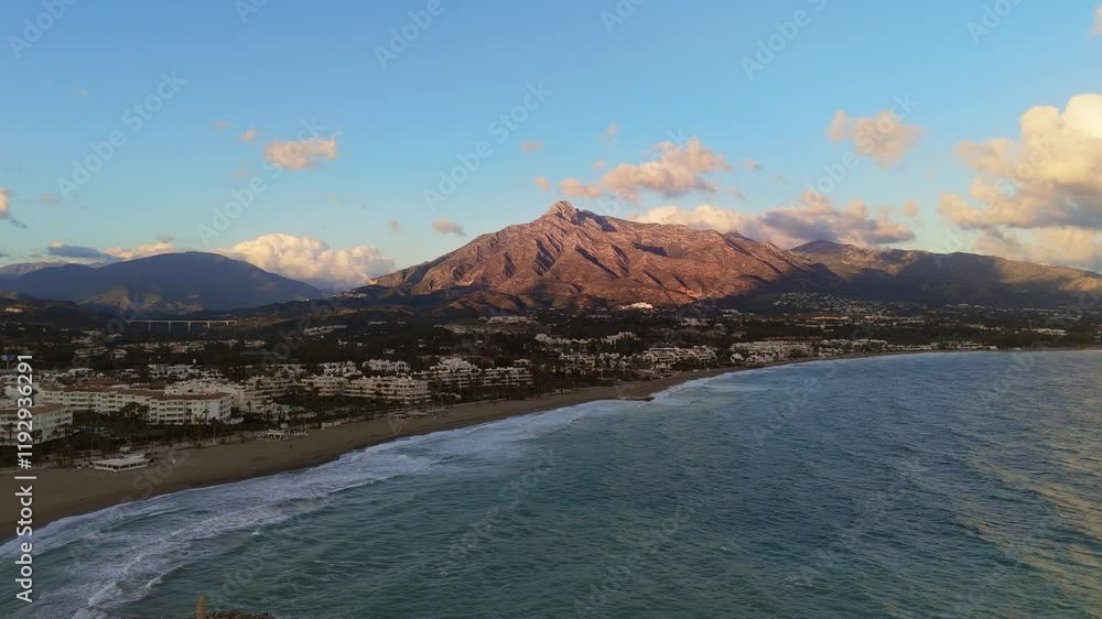Aerial view of Puerto Banus marina with yachts, coastline, and the Sierra Blanca mountains in the background, located in Marbella, Spain Aerial view of Puerto Banus marina with yachts, coastline, and the Sierra Blanca mountains in the background, located in Marbella, Spain