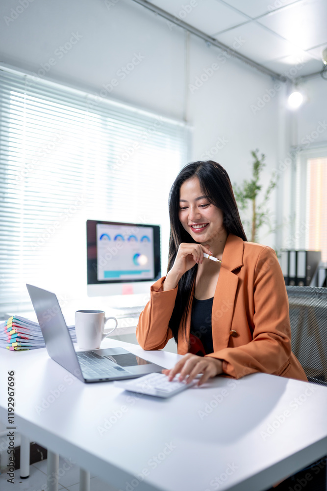 A woman is sitting at a desk with a laptop and a cup of coffee A woman is sitting at a desk with a laptop and a cup of coffee