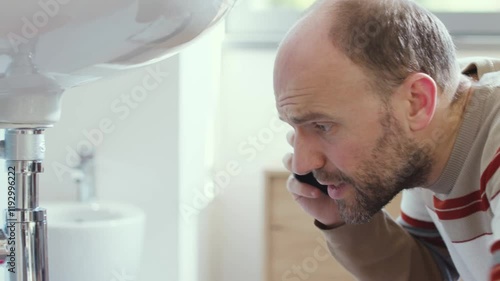 Man calling a professional plumber