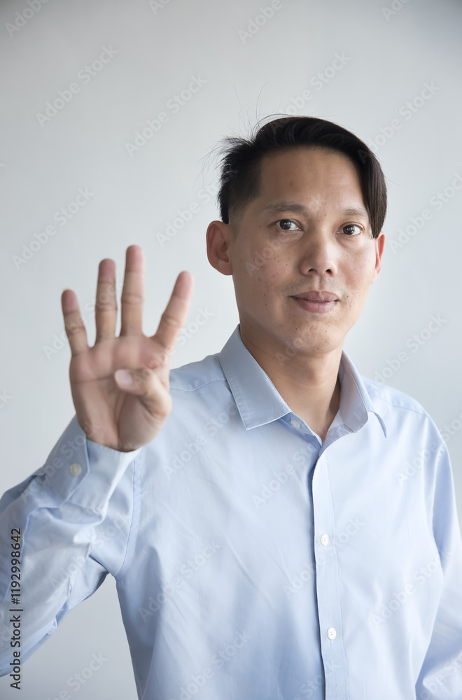 Healthy happy smiling middle aged southeast asian man pointing 4 fingers up, concept of four points, number four, 4th place on isolated background Healthy happy smiling middle aged southeast asian man pointing 4 fingers up, concept of four points, number four, 4th place on isolated background