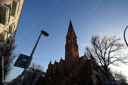 Fassade und Kirchturm aus Klinker der evangelischen Immanuelkirche im neoromanischen Stil im Licht der Abendsonne an der Prenzlauer Allee am Prenzlberg oder Prenzlauer Berg in der Hauptstadt Berlin photo