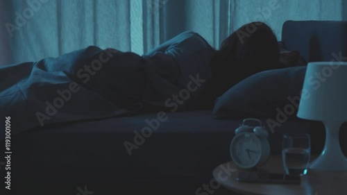 Restless woman in bed at night