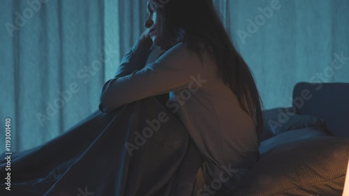 Unhappy woman in bed at night