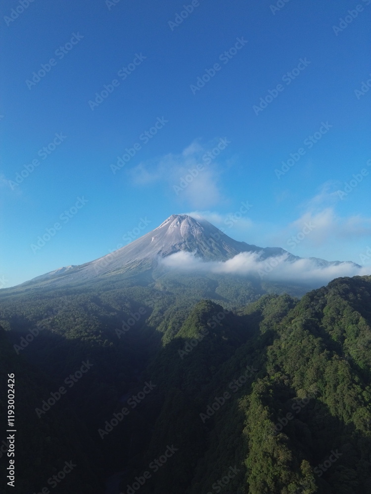 Aerial drone view of Merapi Mountain in Indonesia under blue sky Aerial drone view of Merapi Mountain in Indonesia under blue sky