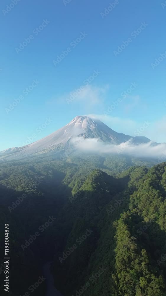 Aerial drone view of Merapi Mountain in Indonesia under blue sky Aerial drone view of Merapi Mountain in Indonesia under blue sky