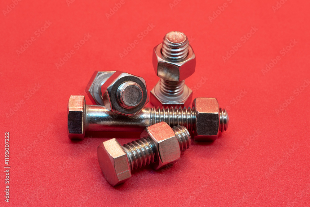 Bolts and nuts on a red background Bolts and nuts on a red background