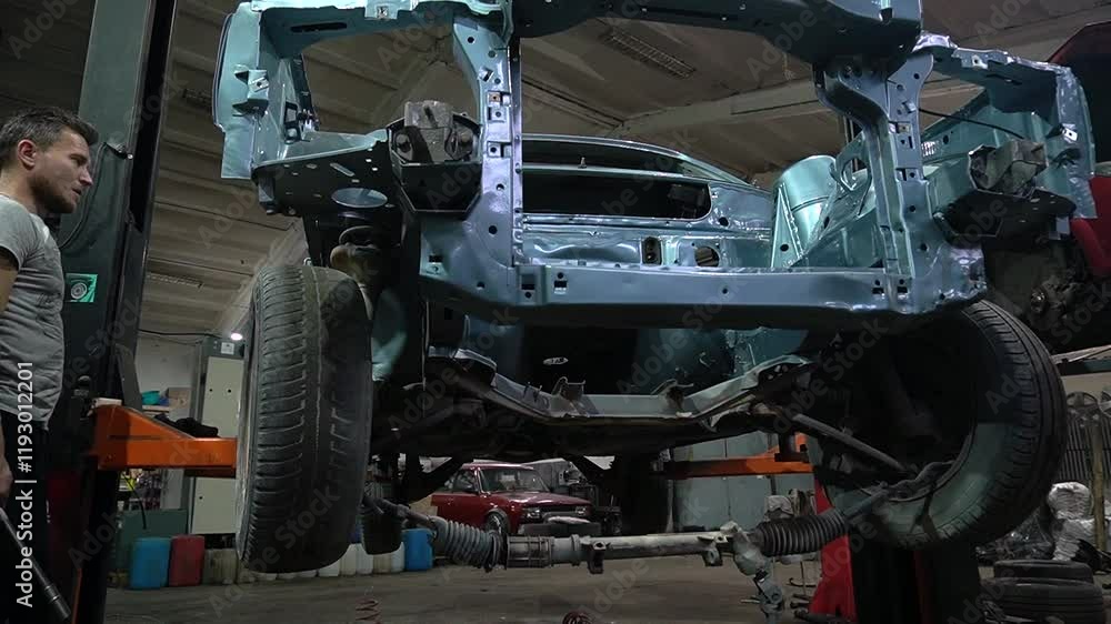 young mechanic repairs and installs an old gray car after a road accident (157) young mechanic repairs and installs an old gray car after a road accident (157)
