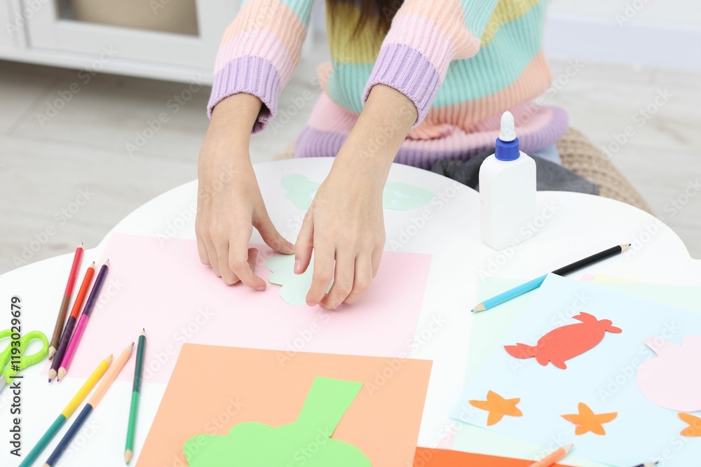 Girl making art project at table indoors, closeup Girl making art project at table indoors, closeup