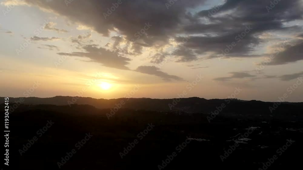 Aerial time lapse of Golden sunset over silhouetted hills. Aerial time lapse of Golden sunset over silhouetted hills.