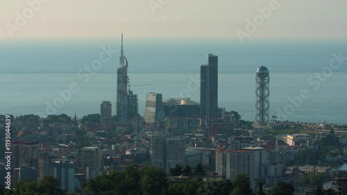 View from above of the city and the sea during the afternoon