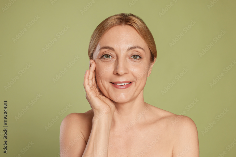Portrait of smiling woman with healthy skin on green background Portrait of smiling woman with healthy skin on green background