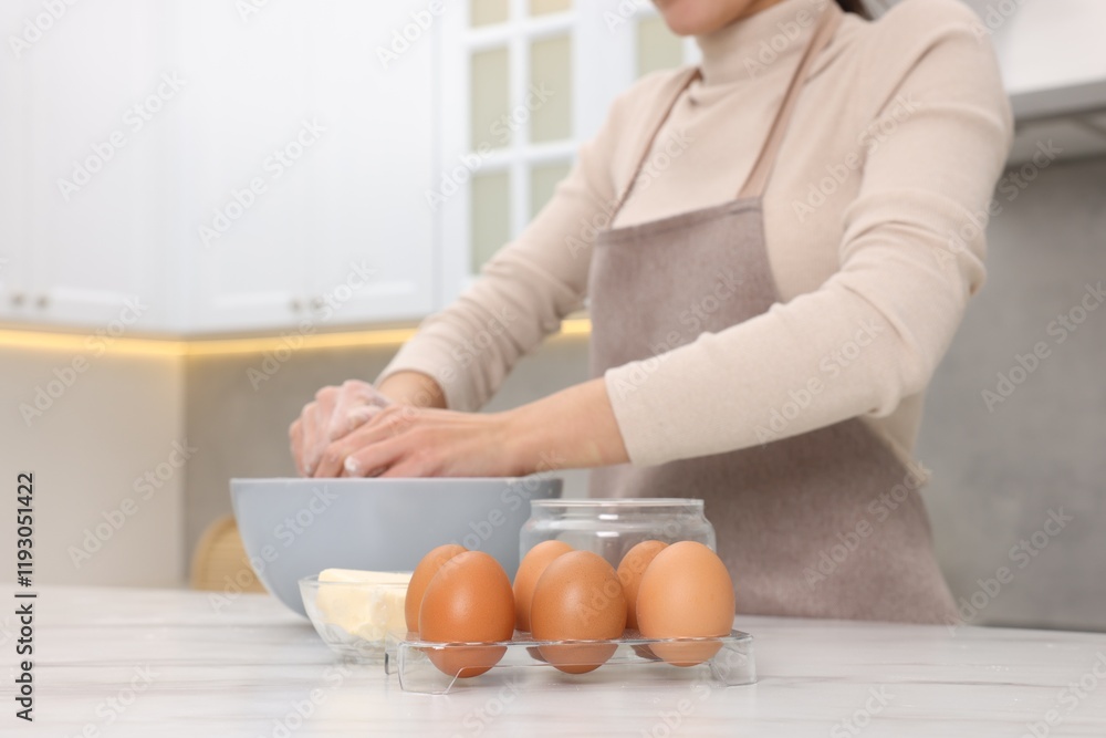 Woman kneading dough in bowl at white table, closeup Woman kneading dough in bowl at white table, closeup