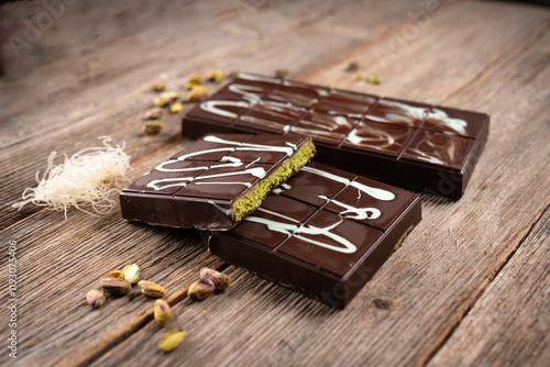 Photography Dubai chocolate bars with pistachio filling and white chocolate drizzle