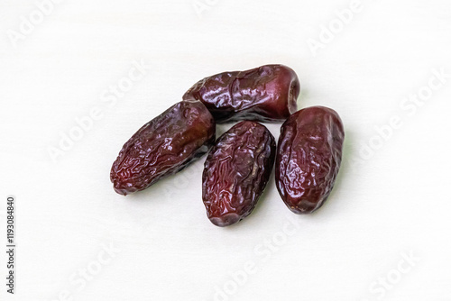 Fresh, dried dates are isolated against a white background. photo