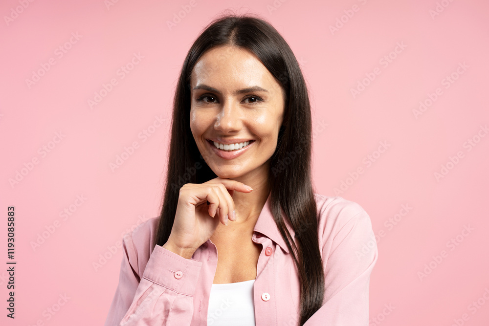 Smiling, beautiful, Latin businesswoman touching her chin on pink background Smiling, beautiful, Latin businesswoman touching her chin on pink background