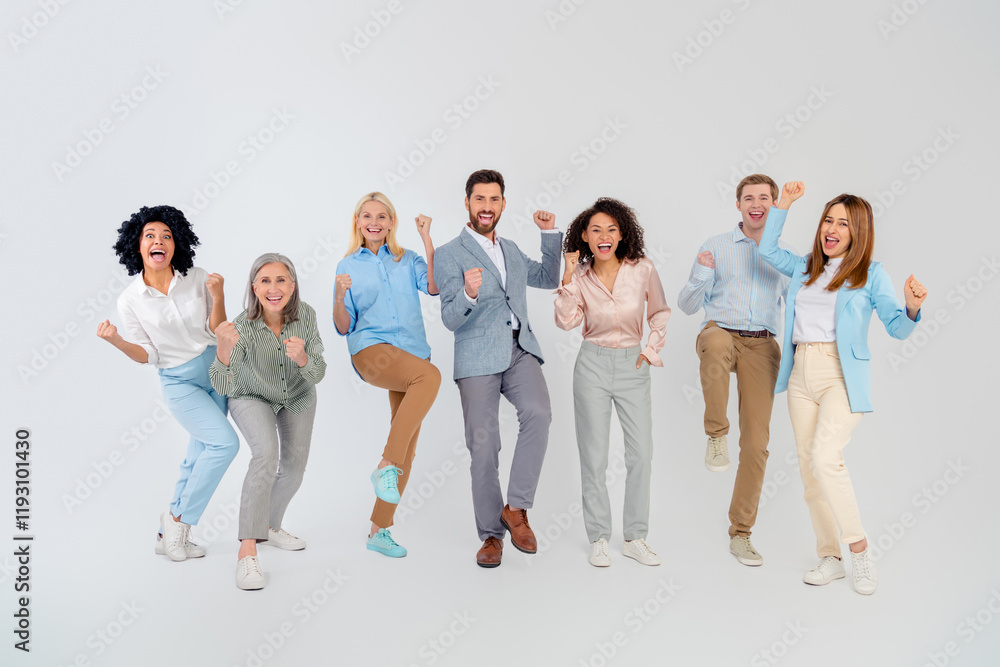 Obraz premium Group of diverse coworkers celebrating success in professional attire against a neutral background