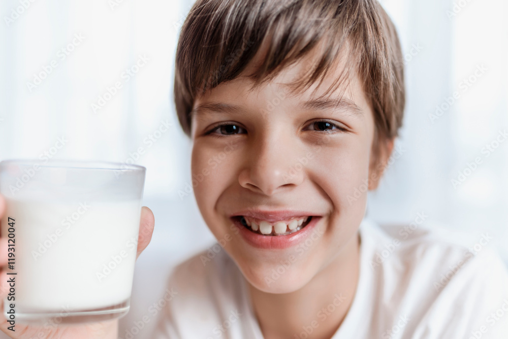 Cute child holding glass of milk and smiling on white background Cute child holding glass of milk and smiling on white background