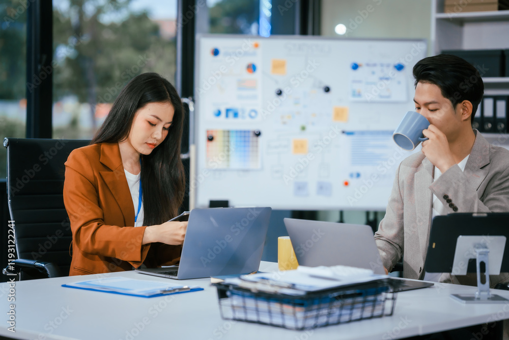 Young businessman and woman are working together at a table, discussing a proposal for cooperation. They review documents focused on business marketing strategies, finance, effective collaboration Young businessman and woman are working together at a table, discussing a proposal for cooperation. They review documents focused on business marketing strategies, finance, effective collaboration