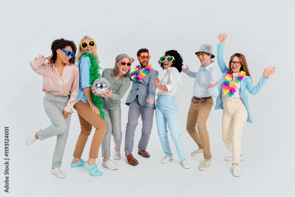 Obraz premium Group of diverse coworkers celebrating together in colorful costumes, showcasing team spirit and unity in a cheerful office environment