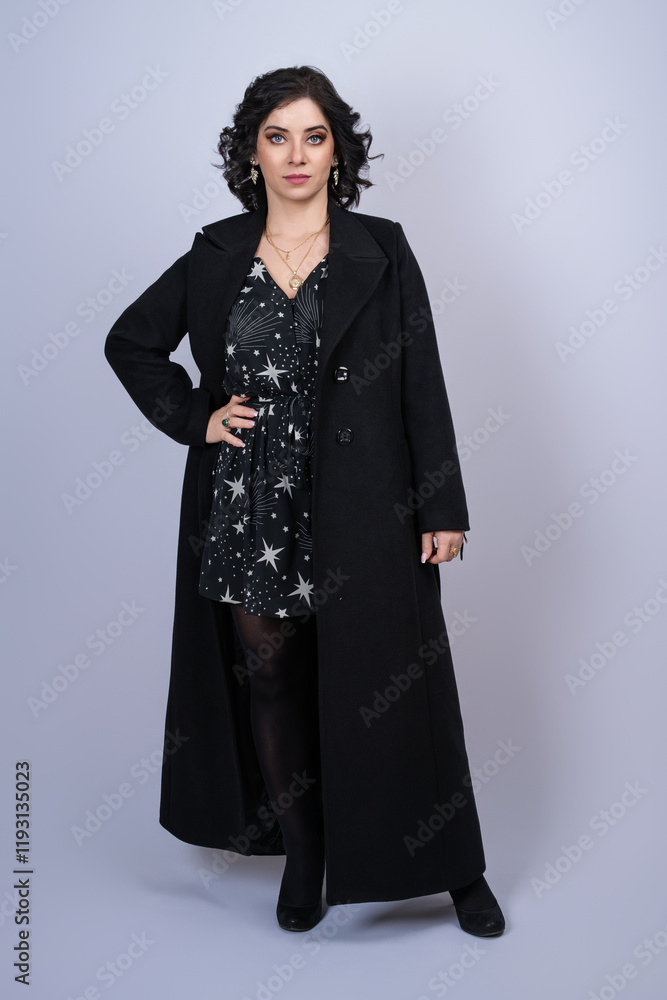 Fashion beautiful woman in a black coat smiling with black hair and blue eyes Fashion beautiful woman in a black coat smiling with black hair and blue eyes