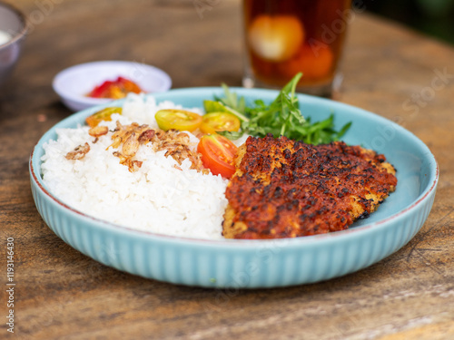 Ikan bakar parape. A traditional Indonesian food menu of grilled fish cooked with a sprinkling of hot chili seasoning, eaten with a portion of white rice. photo