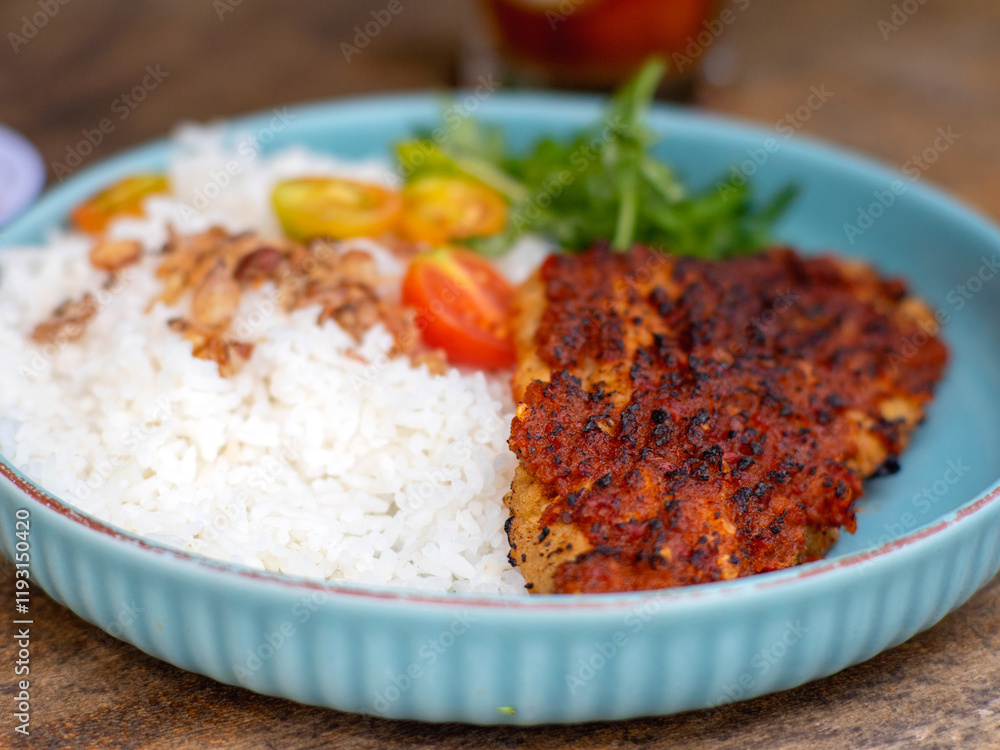 Ikan bakar parape. A traditional Indonesian food menu of grilled fish cooked with a sprinkling of hot chili seasoning, eaten with a portion of white rice. Ikan bakar parape. A traditional Indonesian food menu of grilled fish cooked with a sprinkling of hot chili seasoning, eaten with a portion of white rice.