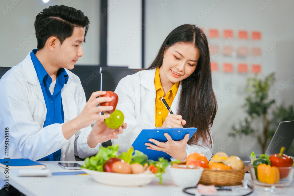 Two nutritionists,female and male, work in a hospital, analyzing vegetable and fruit salads, offering online advice, helping patients embrace clean eating habits and weight control for better health Two nutritionists,female and male, work in a hospital, analyzing vegetable and fruit salads, offering online advice, helping patients embrace clean eating habits and weight control for better health