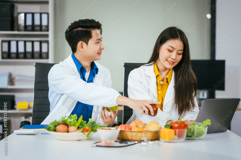Two nutritionists,female and male, work in a hospital, analyzing vegetable and fruit salads, offering online advice, helping patients embrace clean eating habits and weight control for better health Two nutritionists,female and male, work in a hospital, analyzing vegetable and fruit salads, offering online advice, helping patients embrace clean eating habits and weight control for better health