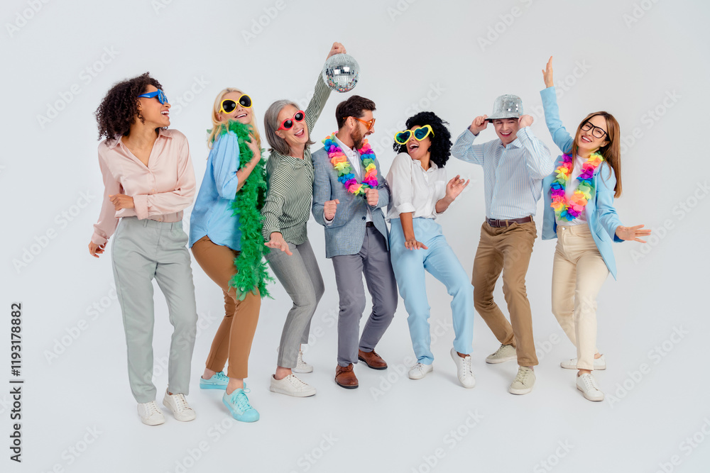Obraz premium Diverse group of colleagues in vibrant costumes enjoying a celebration in an office environment with a neutral gray background